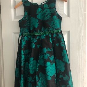 Girls fancy dress. Hi-low hem. Pretty emerald gemstones at waist, back bow.